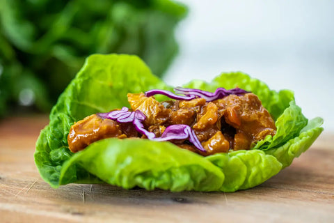 Loma Linda Chik'n BBQ served on a lettuce wrap, plant-based vegan protein in rich BBQ sauce.