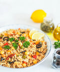 Greek Bowl with chickpeas, brown rice, olives, and sun-dried tomatoes, vegan meal