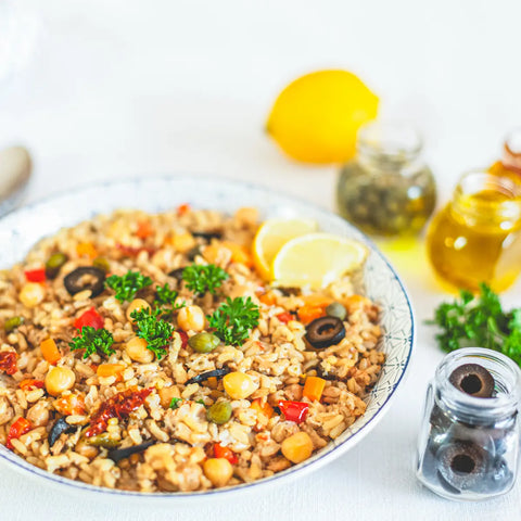 Greek Bowl with chickpeas, brown rice, olives, and sun-dried tomatoes, vegan meal