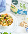 Greek Bowl served in a bowl on a countertop with the packet behind it, vegan meal