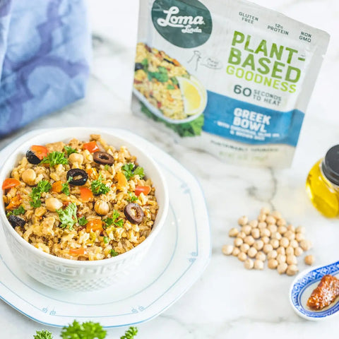 Greek Bowl served in a bowl on a countertop with the packet behind it, vegan meal