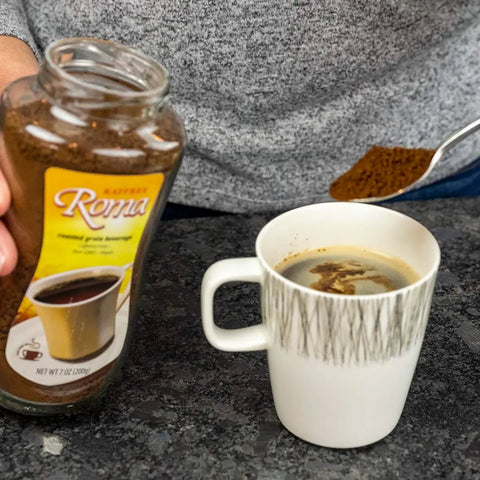 A person spooning Kaffree Roma into a mug, highlighting the ease of preparation for this caffeine-free coffee alternative.