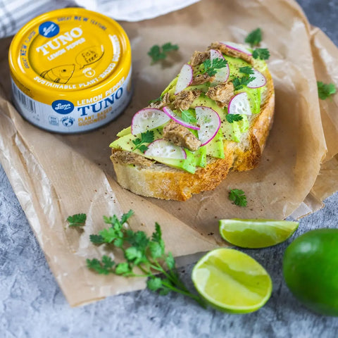 Loma Linda Lemon Pepper TUNO served on bread with avocado, onions, and garnishments as an appetizer, vegan tuna alternative.