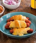 Little Links served as pigs in a blanket on a plate, ready to serve