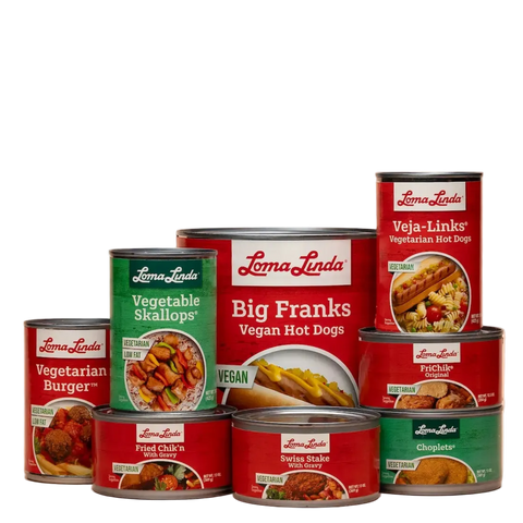 Collection of Loma Linda vegan food cans on a beige background