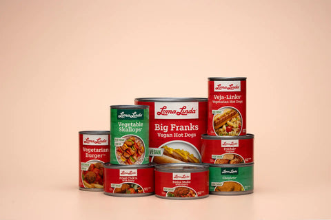 Front view of assorted Loma Linda Food cans in various sizes and varieties.