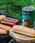 Three Low Fat Big Franks grilling alongside buns on an outdoor barbecue – plant-based hot dog alternative prepared for a classic cookout