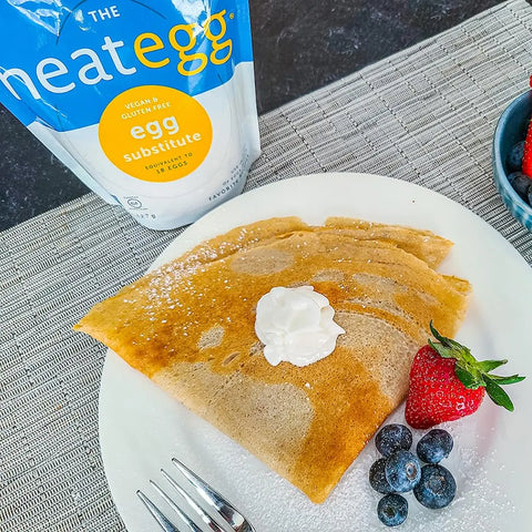 Crepes served with whipped cream and berries, made using neat Egg, plant-based egg replacement.