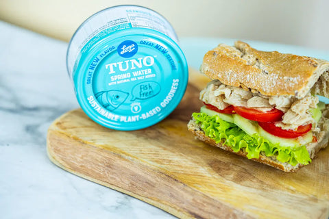 Loma Linda Spring Water TUNO on a sandwich with tomatoes, cucumbers, and lettuce, vegan tuna alternative.