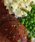 Swiss Stake with Gravy served on a plate with vegetables, vegetarian meal