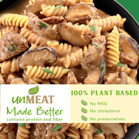 Plant-based beef stroganoff pasta dish with mushrooms and greens in a creamy sauce, labeled 'unMEAT Made Better'.