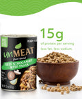 Can of 'unMEAT' plant-based beef stroganoff with pasta next to a bowl of soybeans with 15 grams of protein on a white background.