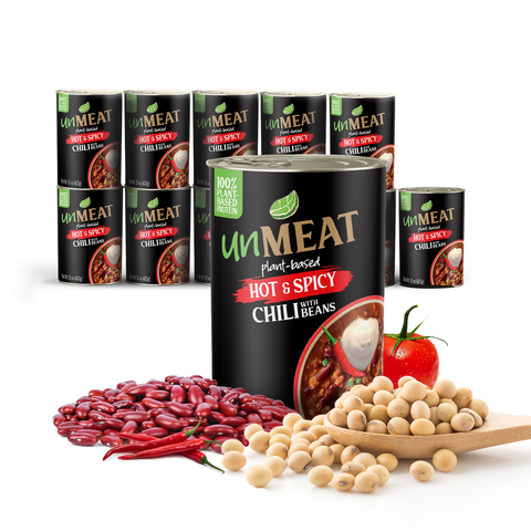Twelve cans of 'Unmeat' hot and spicy chili with beans on a white background, surrounded by ingredients.