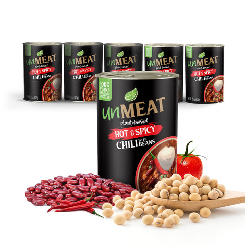 Six cans of 'Unmeat' plant-based hot and spicy chili with ingredients on a white background