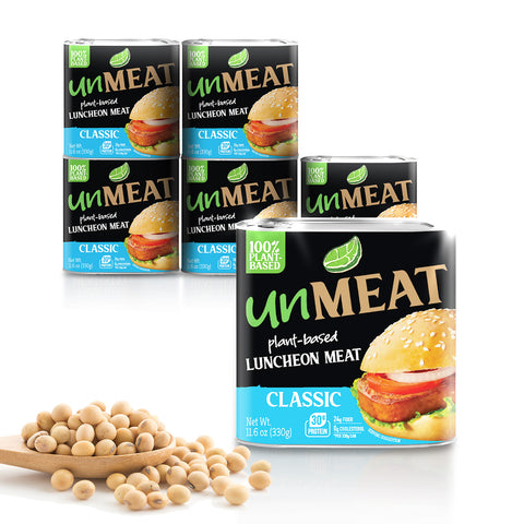 Six UnMeat plant-based classic luncheon meat cans with soybeans on a white background
