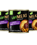 Three cans of 'Unmeat' corned beef style product on a white background