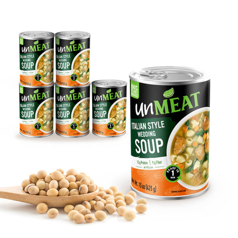 Six cans of UnMeat Italian Style Wedding Soup cans with a wooden spoonful of beans on a white background