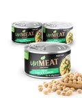 Three cans of unMEAT Thai Chicken Curry on a white background with soybeans and a wooden spoon.