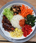 Loma Linda Vegetable Steaks served with rice and a vegetable platter.