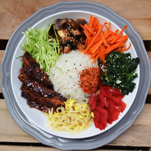 Loma Linda Vegetable Steaks served with rice and a vegetable platter.